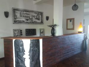 
a living room with a fireplace and a painting on the wall at Hotel Arc En Ciel in Dzamandzar
