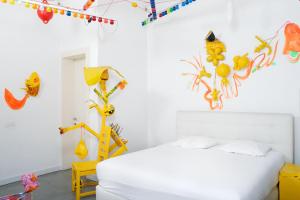 a bedroom with a white bed and decorations on the wall at B&B DRUUM in Brussels