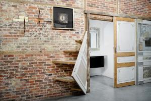 a brick wall with an open door in a room at B&B DRUUM in Brussels