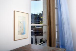 a picture on a wall next to a window at B&B DRUUM in Brussels