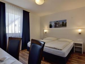 Postel nebo postele na pokoji v ubytování Hotel Olympia