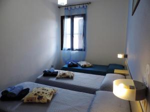 a room with two beds and a window at Residenza Belvedere in Orosei +87 photos