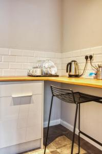 a kitchen with a wooden counter and a chair at Newlands Holidays in Bridport