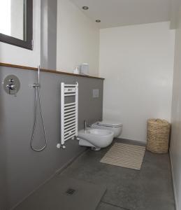 a bathroom with a toilet and a sink in it at Il Lavatoio in Cissano