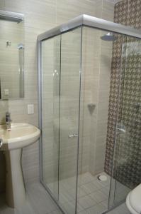 a glass shower in a bathroom with a sink at Hotel Rincon del Cielo in San Juan de los Lagos