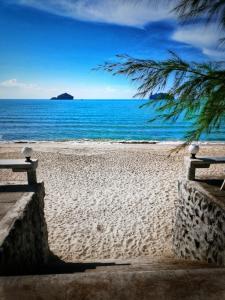 una playa de arena con vistas al océano en Sea Smile Resort, en Prachuap Khiri Khan