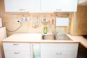 a small kitchen with a sink and a refrigerator at Casa Polignano in Polignano a Mare