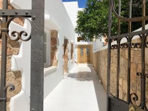 a walkway with a gate and a wooden door at Kostis Parthenis Residence in Malia