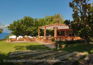 a gazebo with tables and chairs in a yard at Akra V Hotel in Antalya