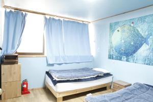Katil atau katil-katil dalam bilik di Baozen Guesthouse