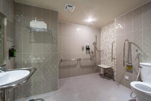 a bathroom with a shower and a sink and a toilet at Stay Hotel - Taichung Zhongqing in Taichung