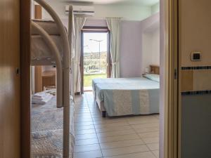 Postel nebo postele na pokoji v ubytování Hotel Cala Reale