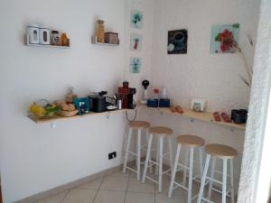 a kitchen with a counter with stools in it at Affittacamere Da Luca in Bonassola +40 photos