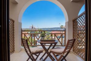 a balcony with a table and chairs and a view at Apart Boutique Giorgos in Ammouliani
