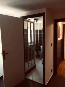 a bathroom with a toilet and a glass door at L entrepote in Dieppe