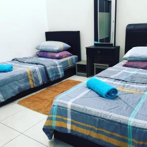 מיטה או מיטות בחדר ב-Mieda Homestay Ipoh with WIFI