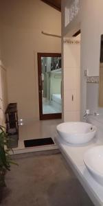 a bathroom with two sinks and a large mirror at Pondok Aldi in Amed +58 photos