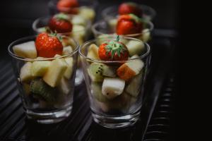 a row of glasses filled with fruit and vegetables at Côté Sax bed and breakfast in Dinant