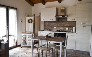 a kitchen with a table and chairs in a room at Nonno Paco Vacanze - pet friendly in Casarza Ligure