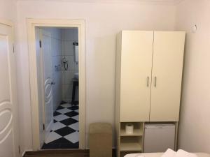 A bed or beds in a room at Bozcaada Aspava Otel