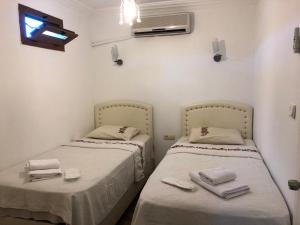 A bed or beds in a room at Bozcaada Aspava Otel