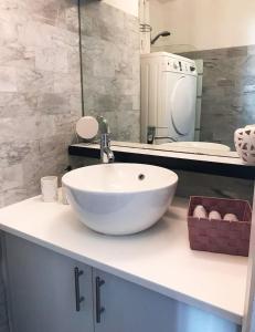 a bathroom with a white bowl sink on a counter at Lovely Flat Champs de Mars Eiffel in Paris