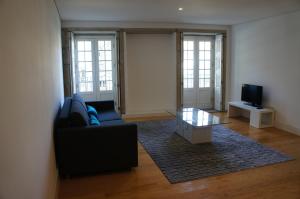 a living room with a couch and a coffee table at Alfandega Apartments in Porto