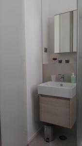 a bathroom with a white sink and a mirror at La casetta di Flavia :guest house molto accogliente in Rionero in Vulture