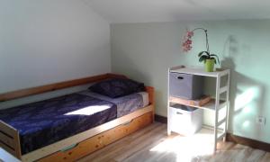 a bedroom with a bed and a night stand at Kaznanou in Saint-Joseph