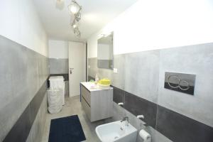a bathroom with a sink and a toilet and a mirror at Casa Vignale in Avola +22 photos