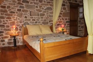 a bedroom with a bed with two lamps on tables at Gîtes de Lez in Laguépie