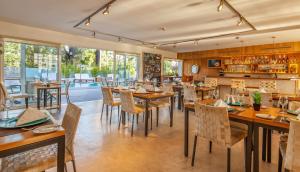 a restaurant with tables and chairs and a pool at AWA Boutique + Design Hotel in Punta del Este