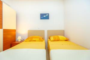 Postel nebo postele na pokoji v ubytování Apartments Vesna