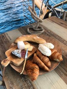 a plate of bread and pastries on a boat at L'Oisette in Ghislenghien