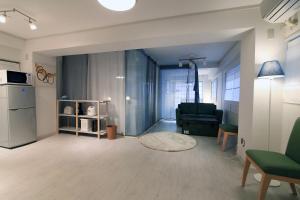 a living room with a couch and a chair at TOMARU MORISITA HOUSE in Tokyo