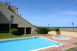 a swimming pool in front of a house with the ocean at VILLA DEL GOLF in Pals