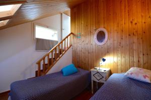 a bedroom with two beds and a stair case at VILLA DEL GOLF in Pals +34 photos