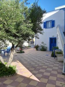 a courtyard with a tree and a white building at Katerina Kafieri Apartments in Firostefani