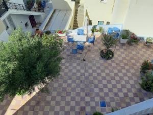 uma vista sobre um pátio com cadeiras e plantas em Katerina Kafieri Apartments em Firostefani
