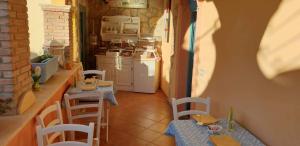 a kitchen with two tables and a counter and a stove at Villamereu in Pula