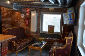 a living room with a couch and a table at Loft Family Hotel in Imatra