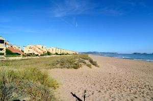 una playa de arena con edificios y el océano en VILLA DEL GOLF, en Pals