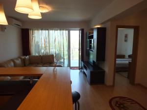 a living room with a couch and a table at SeaSide Piano Bar Apartament in Mamaia