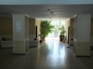 an empty lobby with a large window and a large tile floor at SeaSide Piano Bar Apartament in Mamaia +113 photos