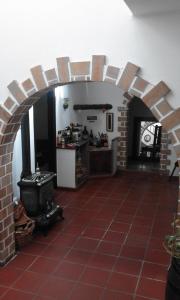 a kitchen with a brick archway with a stove at Home From Home in Teguise