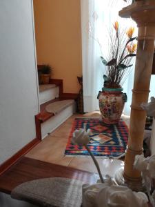 a living room with a vase on the floor at Da Mamma e Papà Sirolo in Sirolo +1 photo