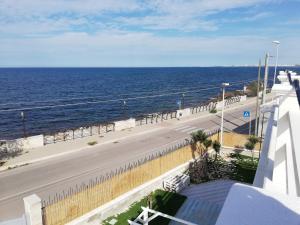 a view of the ocean from the balcony of a building at Casa Viky in Bari Palese +14 photos