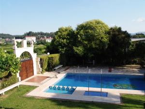 a swimming pool in the yard of a house at Hotel Sena in Caldas de Reis