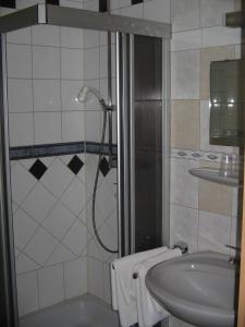 a bathroom with a shower and a sink at Hotel Alt Wassenberg in Wassenberg