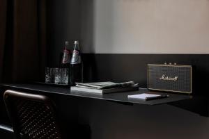 a black table with two bottles of alcohol on it at Chapter Roma in Rome